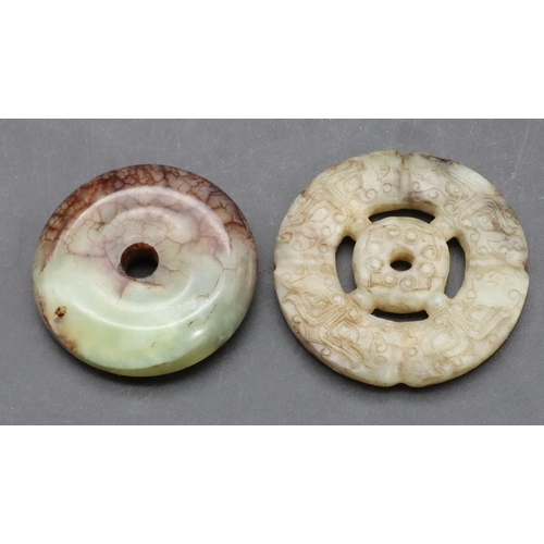 884 - A hardstone circular disc, 5cm diameter and a similar disc, 5.5cm wide (2)