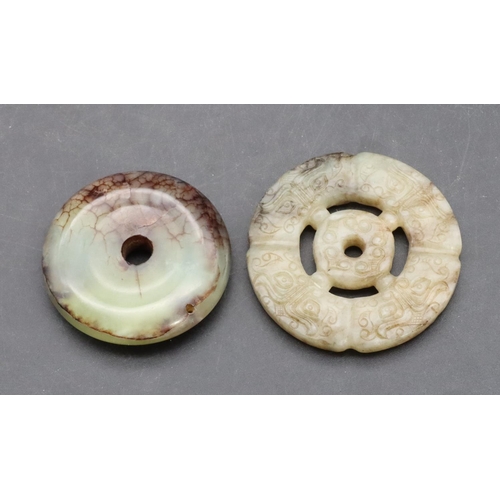 884 - A hardstone circular disc, 5cm diameter and a similar disc, 5.5cm wide (2)