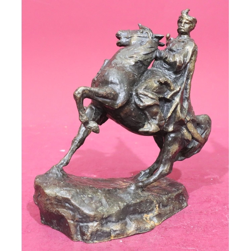 886 - A bronze group of figure on horseback, 24.5cm high