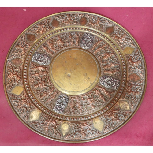 890 - A circular Eastern copper and brass tray with allover embossed figure, floral and scroll decoration,... 