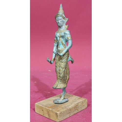 891 - An Eastern bronze and gilt figure of a lady dancer mounted on later wooden base, 30cm high without b... 