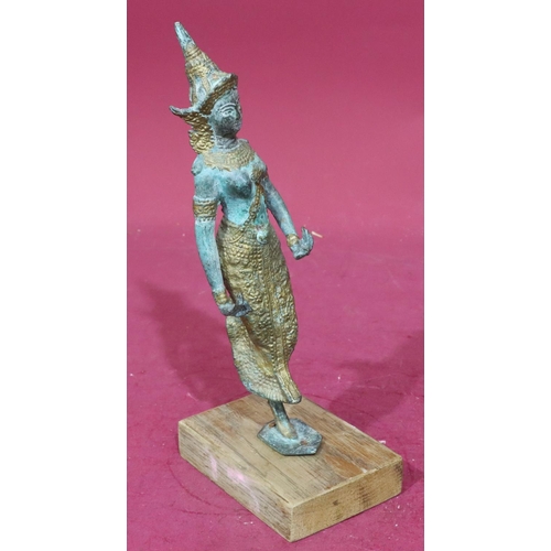 891 - An Eastern bronze and gilt figure of a lady dancer mounted on later wooden base, 30cm high without b... 