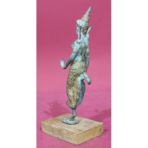 891 - An Eastern bronze and gilt figure of a lady dancer mounted on later wooden base, 30cm high without b... 