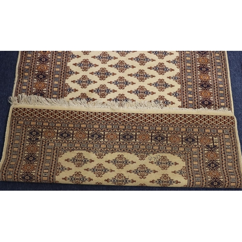 903 - A modern Persian rug on cream, blue and brown ground with allover medallions, 188cm x125cm