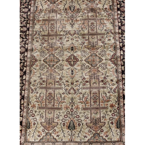 904 - A Persian silk rug on cream and blue ground with multicoloured medallion, floral and leaf decoration... 