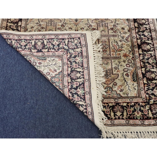 904 - A Persian silk rug on cream and blue ground with multicoloured medallion, floral and leaf decoration... 