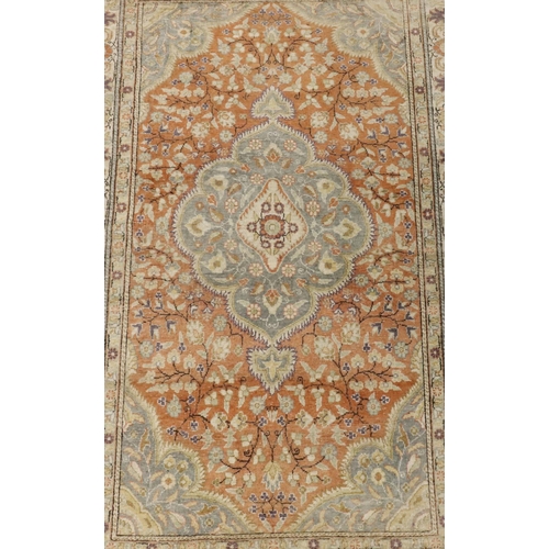 905 - A Persian style rug on cream ground with coloured centre medallion, floral and leaf decoration, 180c... 