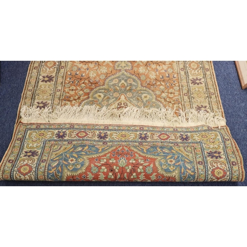 905 - A Persian style rug on cream ground with coloured centre medallion, floral and leaf decoration, 180c... 