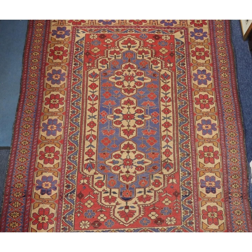 906 - A Kilim style rug on red, blue and cream ground with centre medallion and allover floral motifs, 220... 