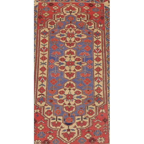 906 - A Kilim style rug on red, blue and cream ground with centre medallion and allover floral motifs, 220... 