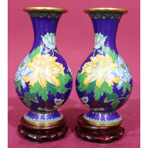 911 - A pair of 20th Century cloisonné round bulbous thin neck trumped shaped vases on blue ground with mu... 