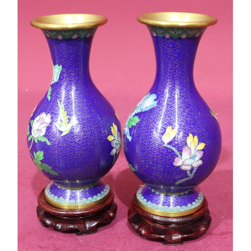 911 - A pair of 20th Century cloisonné round bulbous thin neck trumped shaped vases on blue ground with mu... 