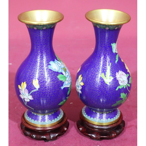 911 - A pair of 20th Century cloisonné round bulbous thin neck trumped shaped vases on blue ground with mu... 