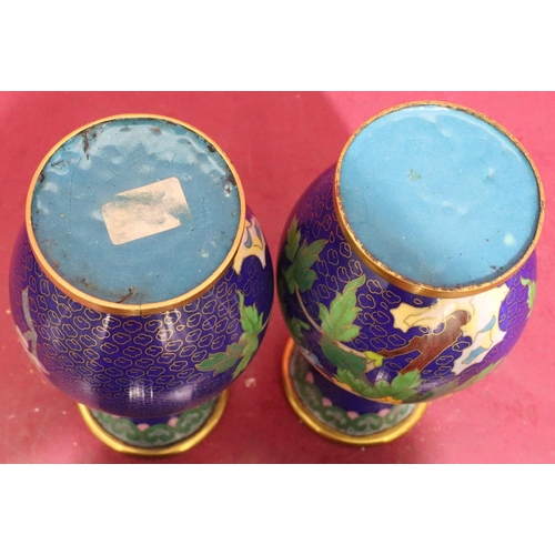 911 - A pair of 20th Century cloisonné round bulbous thin neck trumped shaped vases on blue ground with mu... 