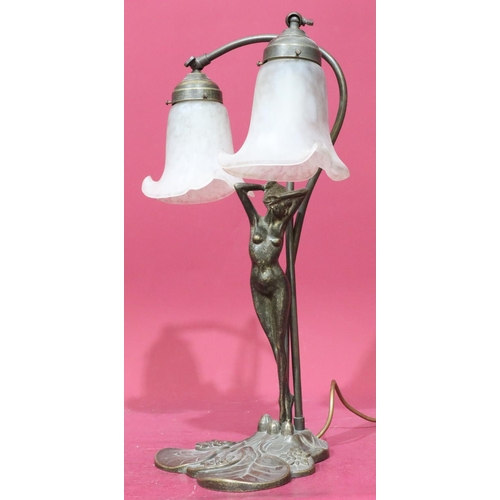 912 - A reproduction gilt metal table lamp in the form of a full length standing female nude with 2 glass ... 