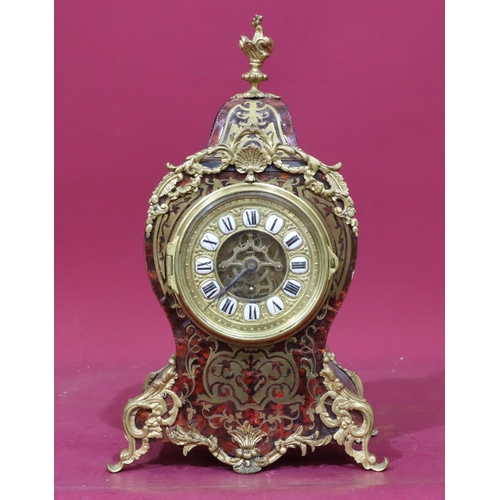 917 - An ebonised and boulle mantel clock with allover raised gilt metal shell, leaf and scroll decoration... 