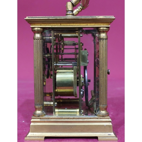 924 - A brass half-hour striking carriage clock with corinthian column supports, swing overhead handle, wh... 