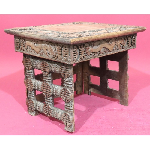 934 - A carved Oriental small rectangular shaped coffee table on 3 collapsible legs, allover carved dragon... 