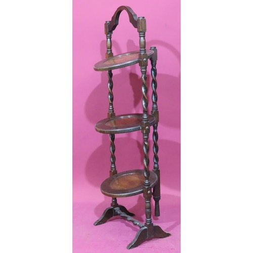 940 - A 1920's oak 3-tier folding cake stand on barley twist supports with splayed feet, 90cm high, 30cm w... 