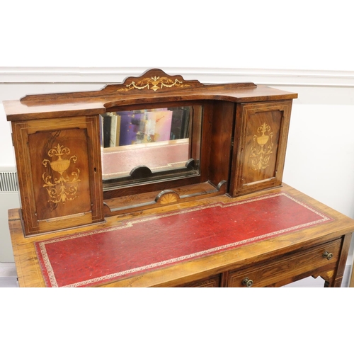 943 - A Victorian rosewood ladies' writing desk with allover inlaid vase, floral and scroll decoration and... 