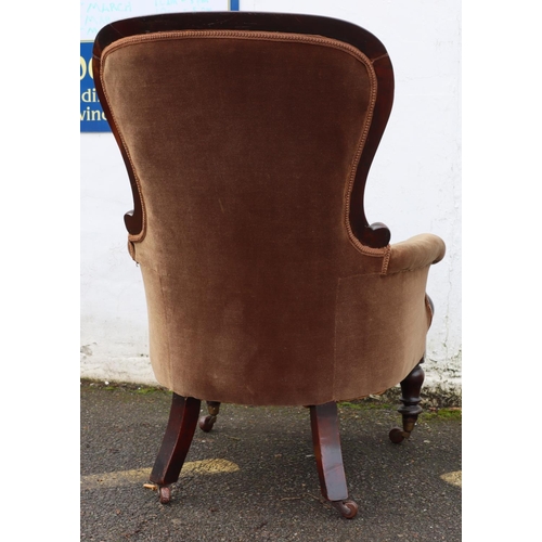 946 - A 19th Century mahogany spoon back armchair with brown velvet overstuffed seat, button back and padd... 