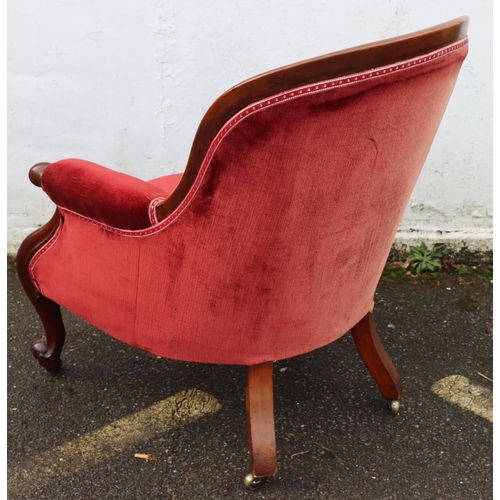 947 - A 19th Century mahogany tub armchair with red velvet overstuffed seat, button back and padded arms o... 