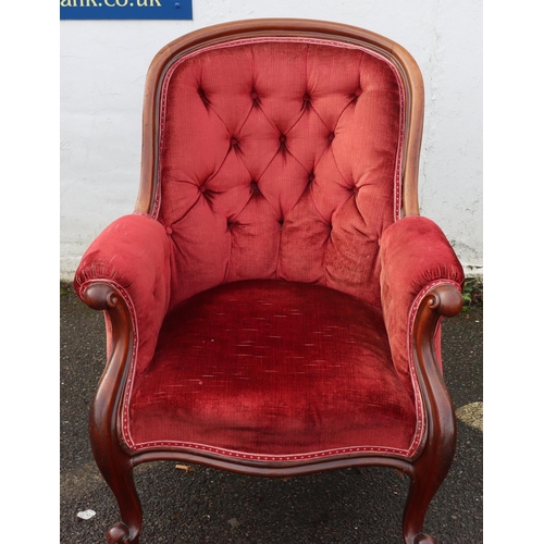 947 - A 19th Century mahogany tub armchair with red velvet overstuffed seat, button back and padded arms o... 