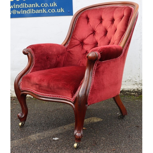 947 - A 19th Century mahogany tub armchair with red velvet overstuffed seat, button back and padded arms o... 