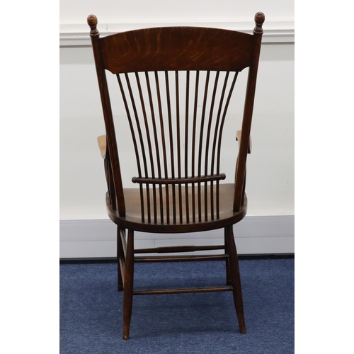 948 - An oak stick back armchair with solid seat on round tapering legs