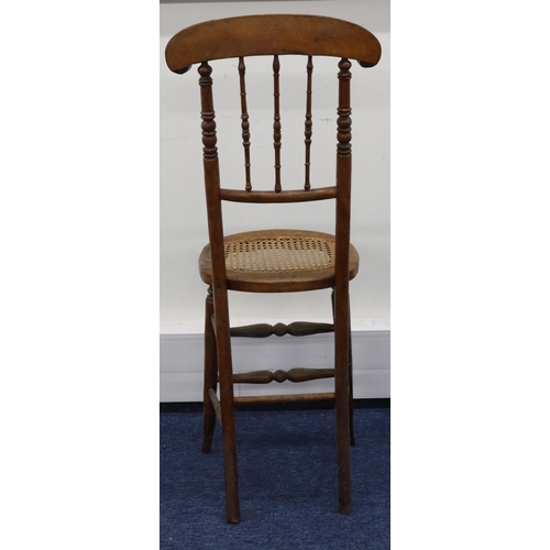 951 - A child's fruitwood tall back chair with spindle back and cane seat on round tapering legs, 105.5cm ... 