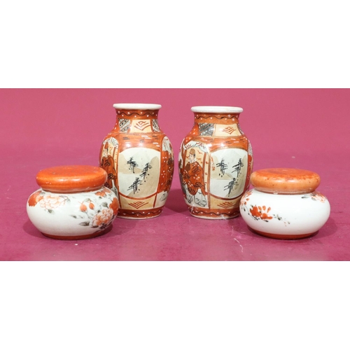 96 - A pair of Oriental small round bulbous lidded inkwells enclosing liners on white and red ground with... 