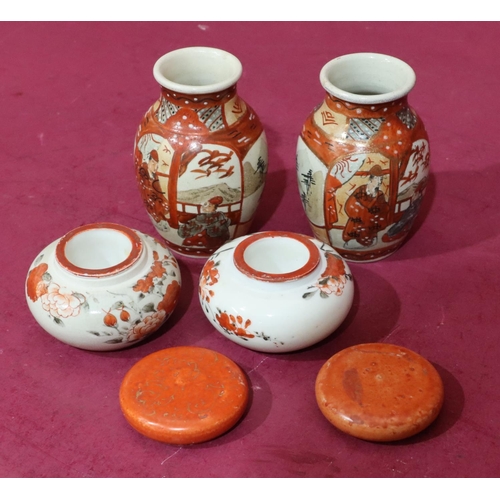 96 - A pair of Oriental small round bulbous lidded inkwells enclosing liners on white and red ground with... 