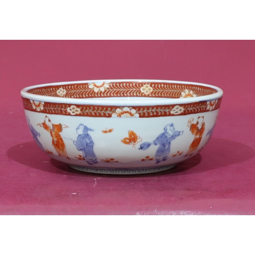 97 - An Oriental round bowl on white, red and blue ground with allover figure, bird, floral, leaf and gil... 