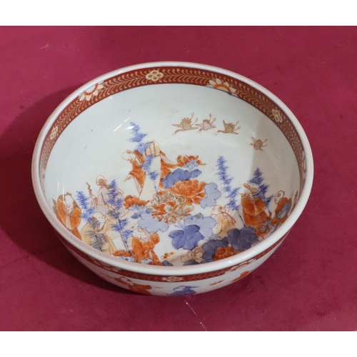 97 - An Oriental round bowl on white, red and blue ground with allover figure, bird, floral, leaf and gil... 