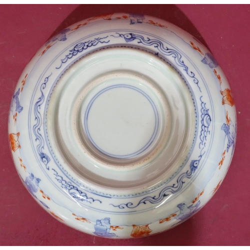 97 - An Oriental round bowl on white, red and blue ground with allover figure, bird, floral, leaf and gil... 