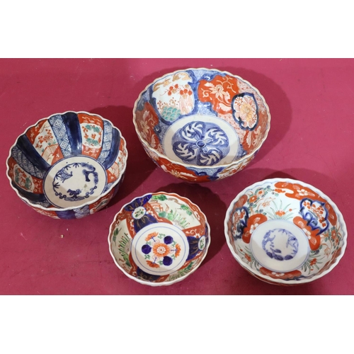 98 - An Imari round scallop shaped bowl on white, red and blue ground with bird, floral, leaf and gilt de... 