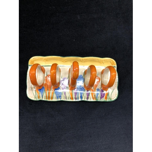 148 - A Clarice Cliff Bazaar crocus pattern rectangular shaped 5-bar toast rack with centre carrying handl... 