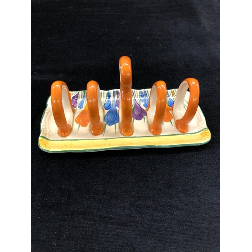 148 - A Clarice Cliff Bazaar crocus pattern rectangular shaped 5-bar toast rack with centre carrying handl... 