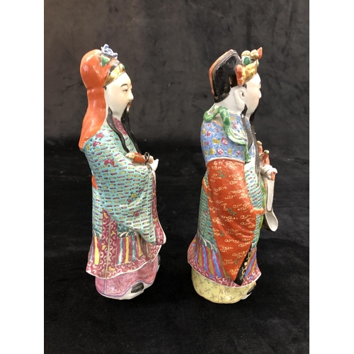 149 - A pair of Chinese glazed earthenware figures of gentleman with multicoloured cloaks, on hardwood sta... 