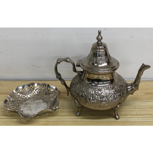 318 - An Eastern silver plated round bulbous shaped teapot with embossed decoration, scroll handle on spla... 