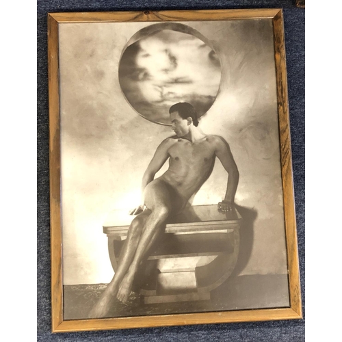 2076 - A framed sepia print of a nude man sitting on a table, 49.5cm x 69cm.