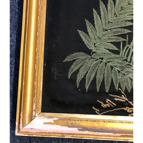 2077 - A painted black fabric picture of birds and trees, 51.5cm x 77cm in gilt frame with brass handle to ... 