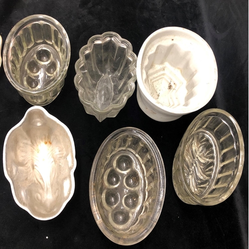 2081 - 4 glass jelly moulds, 1 white ceramic mould and 1 metal rabbit shaped mould.