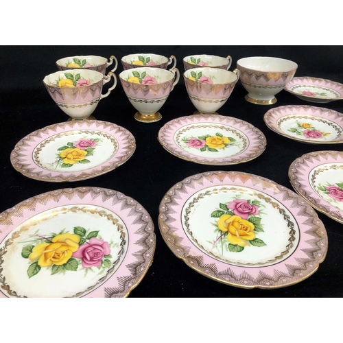 2084 - An Imperial rose patterned bone china part service, 6 cups, 5 saucers, sugar bowl, 5 side plates, 1 ... 