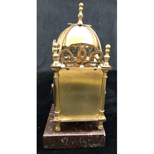 2139 - A small brass battery powered clock on square granite stand, 22cm high including stand.