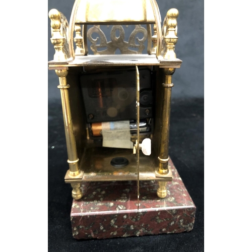 2139 - A small brass battery powered clock on square granite stand, 22cm high including stand.