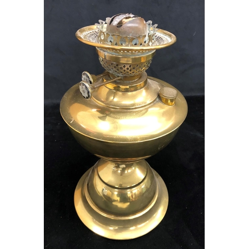 2140 - A gilt metal oil lamp with clear and green glass shade and glass chimney, 55cm high overall.