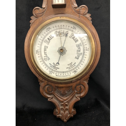 2169 - A Victorian oak aneroid wall barometer 92.5cm high including brass hanging fitting.