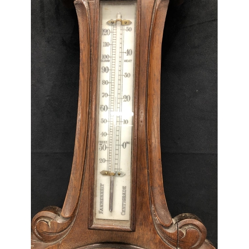 2169 - A Victorian oak aneroid wall barometer 92.5cm high including brass hanging fitting.