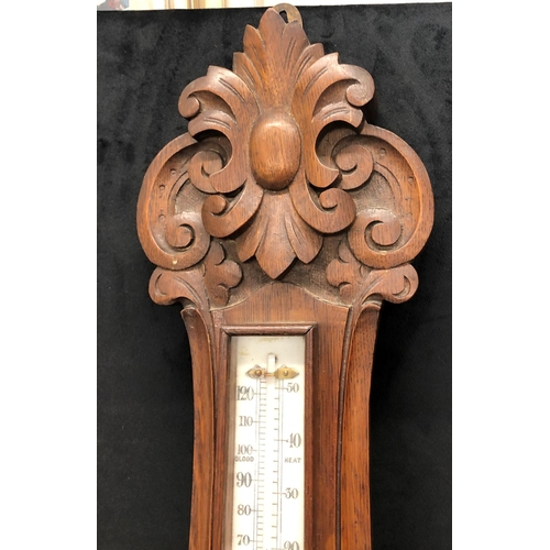 2169 - A Victorian oak aneroid wall barometer 92.5cm high including brass hanging fitting.